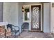 Charming front porch with decorative door and cozy seating area at 676 Otter Brook St, Henderson, NV 89011