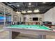 Modern game room featuring a pool table, stylish lighting, and a comfortable seating area at 676 Otter Brook St, Henderson, NV 89011