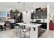 Stylish kitchen with white countertops, black cabinets, and a center island with bar stools at 676 Otter Brook St, Henderson, NV 89011