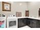 Convenient laundry room with modern washer, dryer, and counter space with cabinets at 676 Otter Brook St, Henderson, NV 89011
