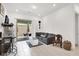 Cozy living room with tile flooring and a sliding glass door to the patio at 676 Otter Brook St, Henderson, NV 89011