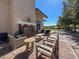 Outdoor lounge area with comfortable seating, a fireplace, and views of landscaped grounds at 676 Otter Brook St, Henderson, NV 89011