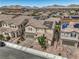 Aerial shot of a two-story home with solar panels in a well-maintained neighborhood with mountain views at 689 Sea Star St, Henderson, NV 89002
