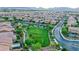 An aerial view showcasing a neighborhood with tree-lined streets, green spaces, and well-maintained homes in a suburban setting at 689 Sea Star St, Henderson, NV 89002