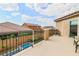 View from the balcony of the patio area with small pool, artificial turf and surrounding houses at 689 Sea Star St, Henderson, NV 89002