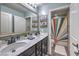 Bright bathroom featuring a double vanity with modern fixtures and a colorful shower curtain at 689 Sea Star St, Henderson, NV 89002