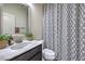Stylish bathroom with a marble countertop, patterned shower curtain, and modern fixtures at 689 Sea Star St, Henderson, NV 89002