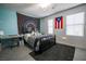 Bedroom with two windows, a work desk and a tapestry over the headboard at 689 Sea Star St, Henderson, NV 89002