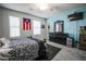 Bedroom with two windows, a dresser and a Puerto Rican flag hanging on the wall at 689 Sea Star St, Henderson, NV 89002