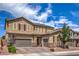 Beautiful two-story home with a three-car garage, stone accents, and well-manicured landscaping at 689 Sea Star St, Henderson, NV 89002