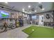 Versatile golf simulator room with TV screen and various accessories at 689 Sea Star St, Henderson, NV 89002