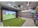 Impressive golf simulator room for sports enthusiasts featuring a large projector screen at 689 Sea Star St, Henderson, NV 89002