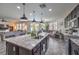 Granite kitchen island with modern fixtures overlooks the living room in a sunny home at 689 Sea Star St, Henderson, NV 89002