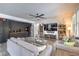 Inviting living room featuring tile floors, comfortable sofas, and a media center at 689 Sea Star St, Henderson, NV 89002