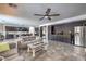 Open-concept living room features a modern ceiling fan, kitchen bar seating and tiled floor at 689 Sea Star St, Henderson, NV 89002