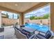 Inviting covered patio with elegant outdoor seating overlooking a sparkling pool and landscaping at 689 Sea Star St, Henderson, NV 89002