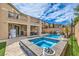 Backyard oasis with a sparkling pool, integrated spa, and comfortable outdoor seating at 689 Sea Star St, Henderson, NV 89002