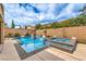 Inviting pool and spa surrounded by desert landscaping, offering a refreshing backyard oasis at 689 Sea Star St, Henderson, NV 89002