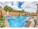 Refreshing pool with waterfall feature, landscaping, and inviting outdoor seating for relaxation at 689 Sea Star St, Henderson, NV 89002