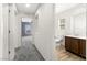 Hallway featuring neutral carpeting and views of the bathroom and bedroom at 7189 Ashcroft St, North Las Vegas, NV 89084