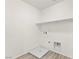 Laundry room features wood-look flooring and convenient washer/dryer hookups and shelving at 7189 Ashcroft St, North Las Vegas, NV 89084