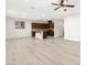 Bright open-concept living room with modern gray wood flooring and stylish ceiling fan and open to the kitchen at 7189 Ashcroft St, North Las Vegas, NV 89084