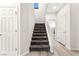 Carpeted stairway with white banister and trim leads to the upper level, featuring a skylight for natural light at 7189 Ashcroft St, North Las Vegas, NV 89084