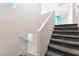 Carpeted stairs with geometric accent wall leads to the upper level, providing a stylish transition between floors at 7189 Ashcroft St, North Las Vegas, NV 89084