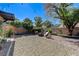 This backyard features a gravel fire pit area and established landscaping at 724 Smokey Mountain Ave, Henderson, NV 89012