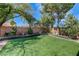 This backyard offers artificial grass, established landscaping, and privacy at 724 Smokey Mountain Ave, Henderson, NV 89012