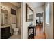 Well-lit bathroom with a single sink, toilet, walk-in shower, tile flooring and nice wall decor at 724 Smokey Mountain Ave, Henderson, NV 89012