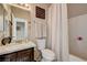 Cozy bathroom with dark cabinets, a toilet, a tub-shower combo, and neutral paint at 724 Smokey Mountain Ave, Henderson, NV 89012