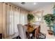 Bright dining area featuring neutral curtains and a view to the backyard at 724 Smokey Mountain Ave, Henderson, NV 89012