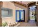Front entrance featuring a decorative wrought iron gate and a blue painted door at 724 Smokey Mountain Ave, Henderson, NV 89012