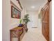 Inviting foyer featuring a decorative plant, butterfly artwork, and rustic furniture at 724 Smokey Mountain Ave, Henderson, NV 89012