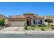 Charming single-story home featuring a desert landscape, an attached garage and a well-manicured lawn at 724 Smokey Mountain Ave, Henderson, NV 89012