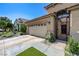 Exterior of the house showcasing the 2-car garage, wrought iron gate, and a meticulously kept landscape at 724 Smokey Mountain Ave, Henderson, NV 89012