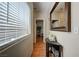 Hallway with hardwood floors, a side table, a framed mirror, and access to other rooms at 724 Smokey Mountain Ave, Henderson, NV 89012