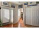 This hallway features hardwood floors, white doors, and access to the backyard at 724 Smokey Mountain Ave, Henderson, NV 89012