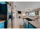 Stainless steel refrigerator complementing granite countertops and kitchen island at 724 Smokey Mountain Ave, Henderson, NV 89012