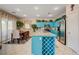 Bright kitchen features stainless steel appliances and an island with granite countertops and wine rack storage at 724 Smokey Mountain Ave, Henderson, NV 89012