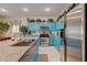 Spacious kitchen with blue cabinetry, granite countertops, and stainless steel appliances at 724 Smokey Mountain Ave, Henderson, NV 89012