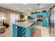 Kitchen with stainless steel appliances and an island with granite countertops sits adjacent to the dining area at 724 Smokey Mountain Ave, Henderson, NV 89012