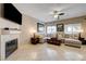 Bright living room features a fireplace, neutral walls, and a comfortable sectional sofa with decorative pillows at 724 Smokey Mountain Ave, Henderson, NV 89012