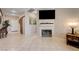 Living room features a tiled fireplace, a large flat-screen TV, and easy access to the front entrance and hallway at 724 Smokey Mountain Ave, Henderson, NV 89012