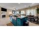 Open concept living room with kitchen island, fireplace, and dining area at 724 Smokey Mountain Ave, Henderson, NV 89012