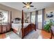 Main bedroom showcasing a four-poster bed, hardwood floors and ample natural light at 724 Smokey Mountain Ave, Henderson, NV 89012