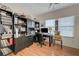 Well-lit office with hardwood floors, a desk, computer, shelves, and plenty of decor at 724 Smokey Mountain Ave, Henderson, NV 89012
