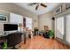 This home office space features wood floors, natural light, and a ceiling fan at 724 Smokey Mountain Ave, Henderson, NV 89012