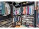 Spacious closet with dark wood shelving, shoe racks, drawers, and rods for hanging clothes at 724 Smokey Mountain Ave, Henderson, NV 89012